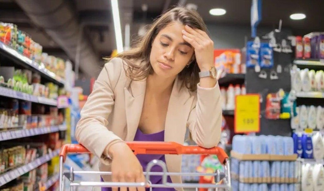Person overwhelmed and confused in a supermarket aisle wondering why they are reacting this way